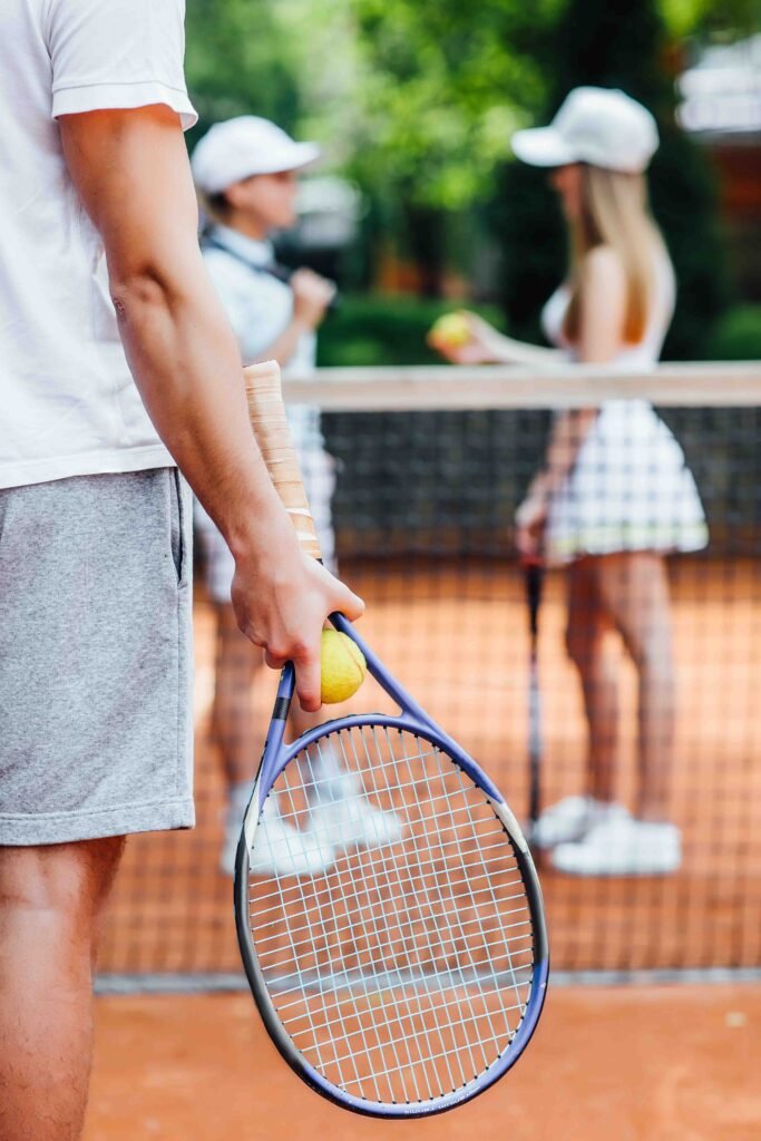 a tennis player man prepares to serve a tennis ball during a match..